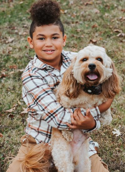 Little Boy holding an apricot Cavapoo